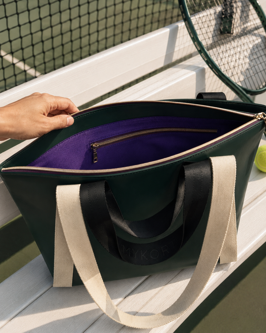 The Mykort Club Tote open on a bench with purple ripstop lining visible