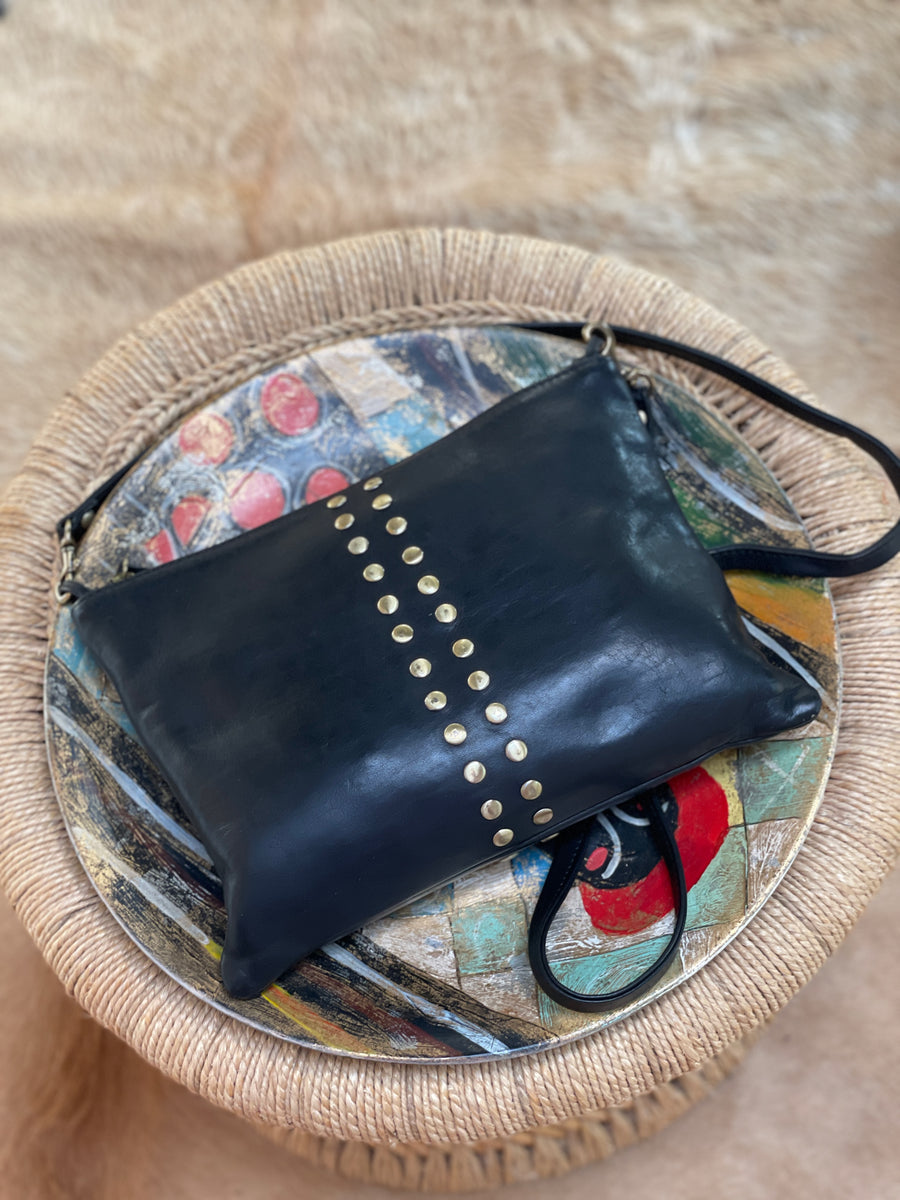 Quinn fold-over leather crossbody, opened to show the interior