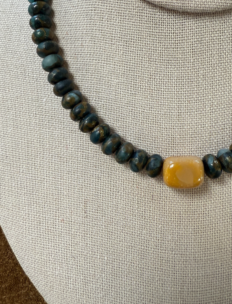 Deep blue-green labradorite bead necklace with honey-colored ceramic bead, detail view