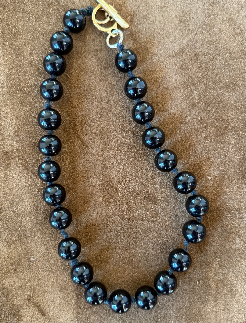 Glossy jet-black knotted bead necklace, detail view