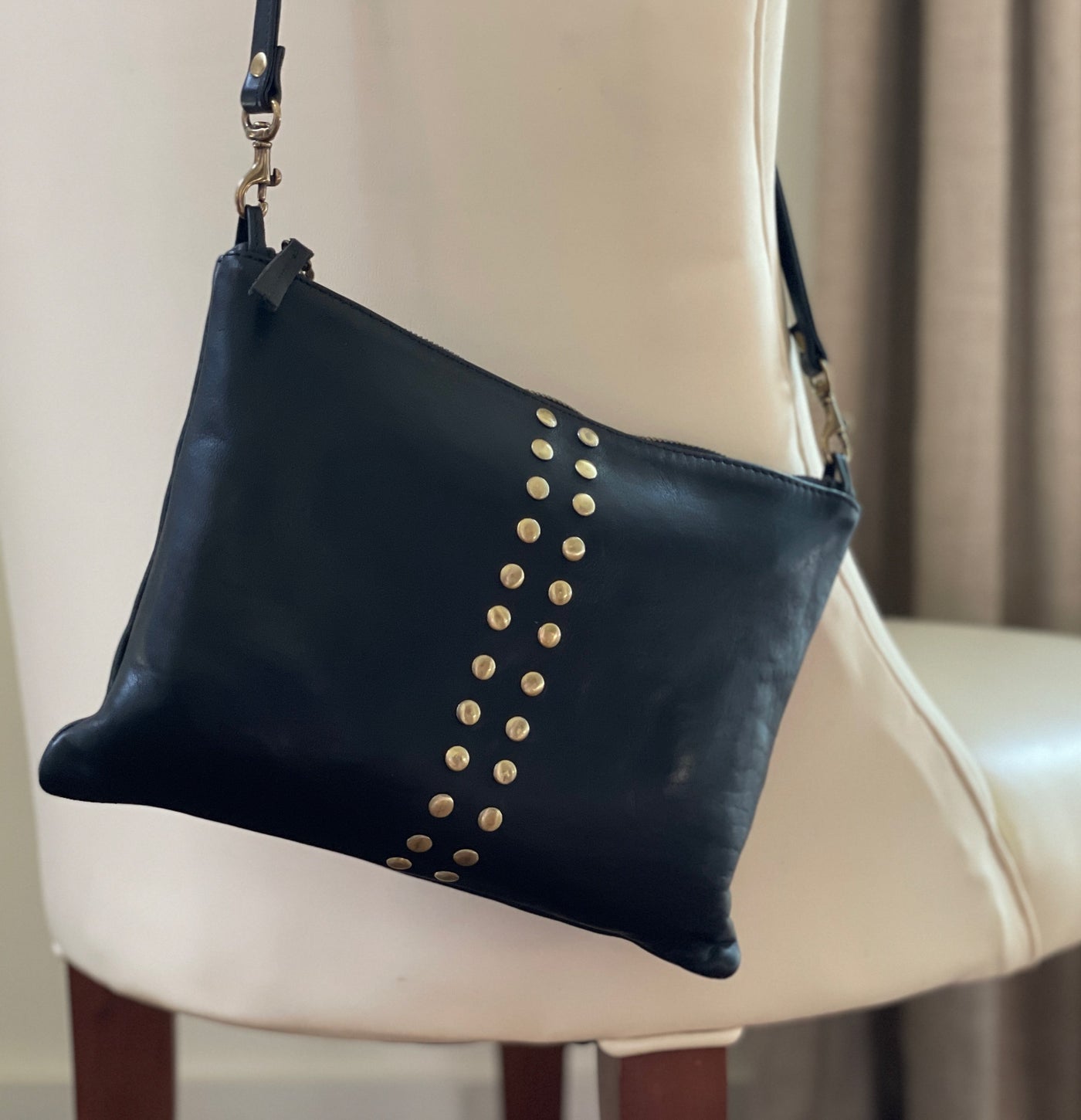 Quinn fold-over leather crossbody bag in cognac